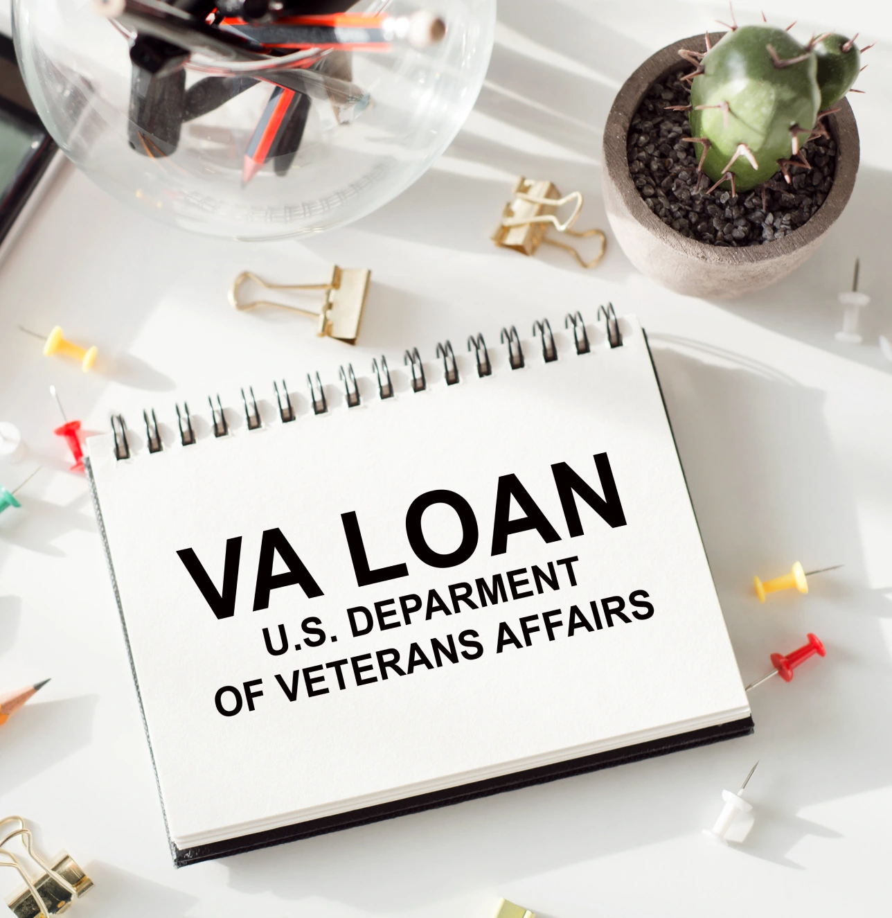 Notebook displaying 'VA Loan U.S. Department of Veterans Affairs' on a desk.