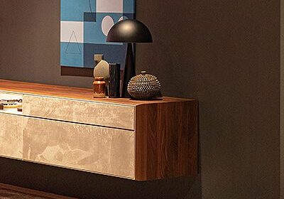 Modern sideboard with decorative items and lamp.