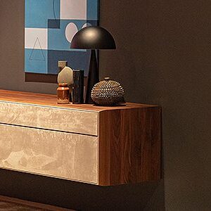 Modern sideboard with decorative items and lamp.