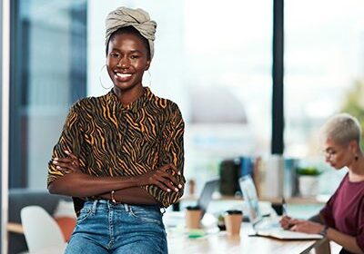 Smiling woman standing in modern office.