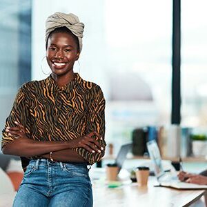 Smiling woman standing in modern office.